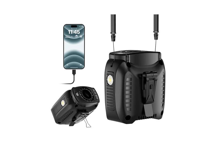 Black portable power station with two fold-out LED light towers, built-in handle, and a phone plugged in for charging.