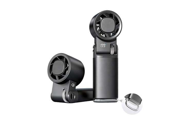 Black portable handheld fan with a round front grille and an adjustable head, shown with a clip-on unit and a small cap accessory.