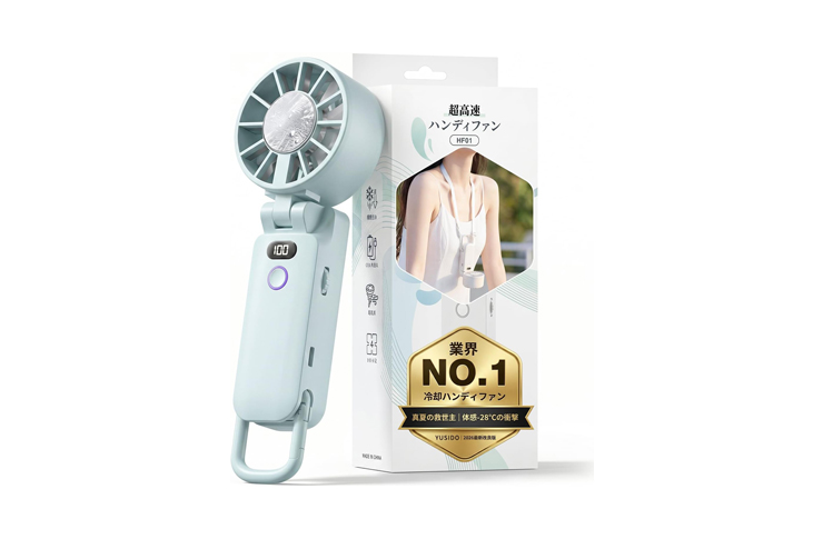 0_62427 - crasi Pastel blue handheld portable fan with a circular blade head, shown beside its packaging box featuring a model in a white top and a gold No.1 badge on the front panel.