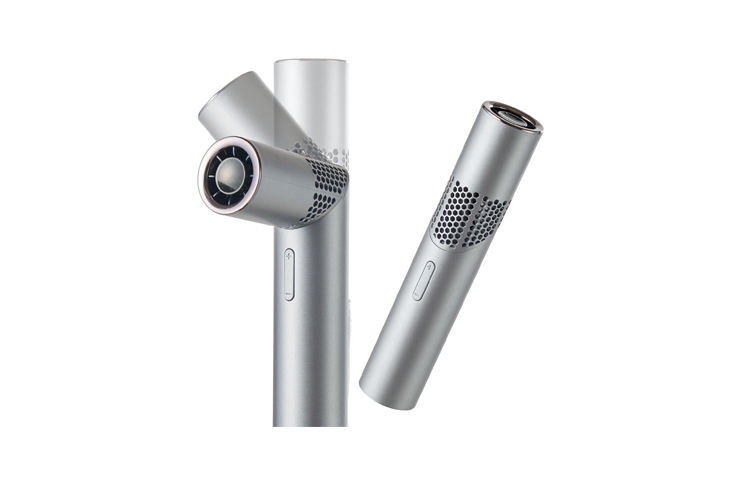 Two silver cylindrical hair styling tools with vented casings and a curling attachment.